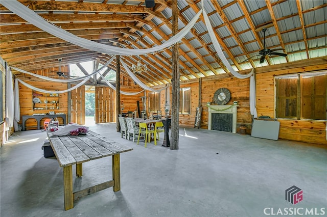 garage with ceiling fan and wooden walls