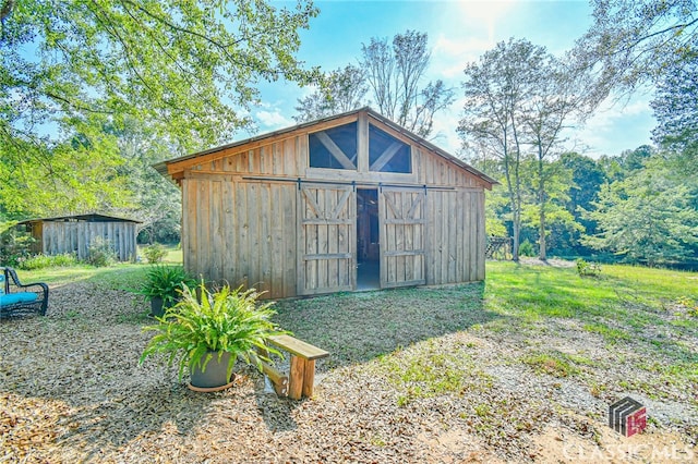 view of outbuilding with a yard