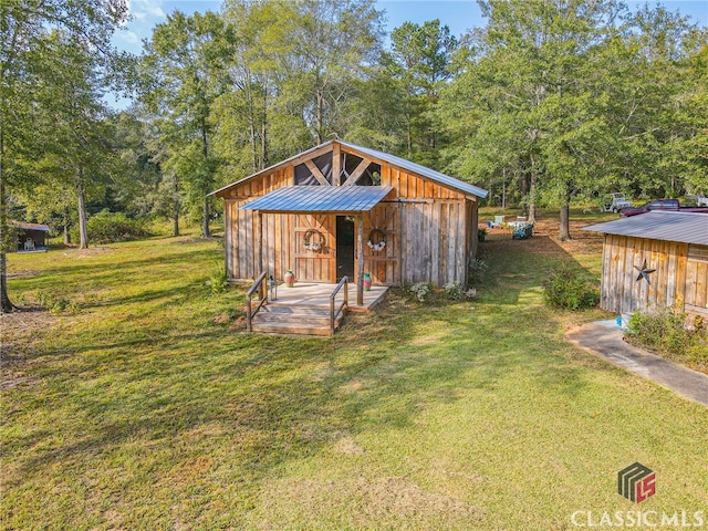 view of outbuilding featuring a yard