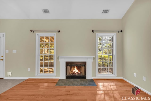 unfurnished living room featuring hardwood / wood-style flooring