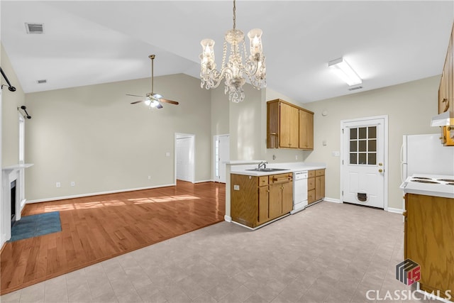 kitchen with ceiling fan with notable chandelier, white appliances, extractor fan, sink, and light hardwood / wood-style flooring