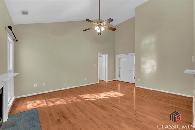 unfurnished living room featuring ceiling fan, wood-type flooring, and high vaulted ceiling