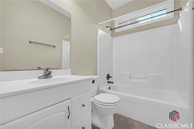 full bathroom with bathtub / shower combination, vanity, tile patterned floors, and toilet