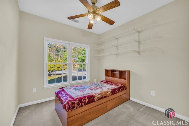 bedroom with ceiling fan and light carpet