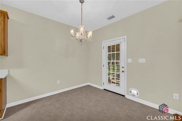 unfurnished room featuring a notable chandelier