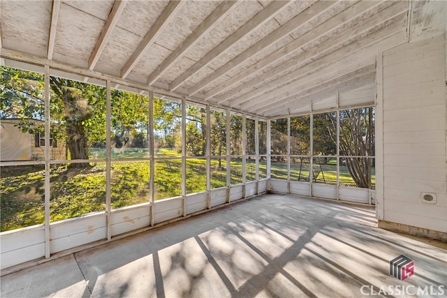 unfurnished sunroom featuring a healthy amount of sunlight and vaulted ceiling