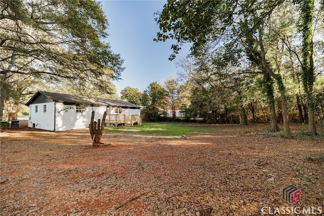 view of yard with a wooden deck