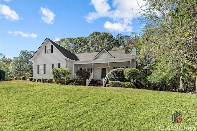 view of property with covered porch and a front lawn