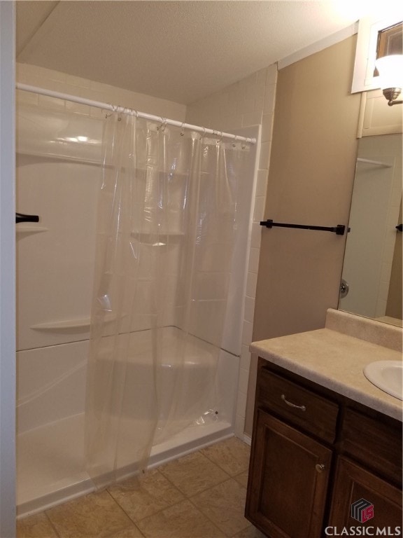 bathroom featuring tile patterned floors, vanity, and shower / bath combo with shower curtain