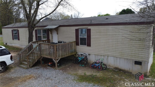 back of property with a wooden deck