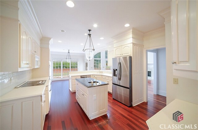 kitchen featuring kitchen peninsula, dark hardwood / wood-style flooring, white cabinets, stainless steel fridge with ice dispenser, and hanging light fixtures