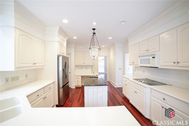 kitchen with stainless steel refrigerator with ice dispenser, cooktop, dark hardwood / wood-style floors, white cabinetry, and hanging light fixtures