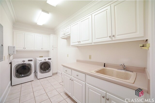 clothes washing area featuring cabinets, ornamental molding, sink, light tile patterned floors, and washing machine and clothes dryer