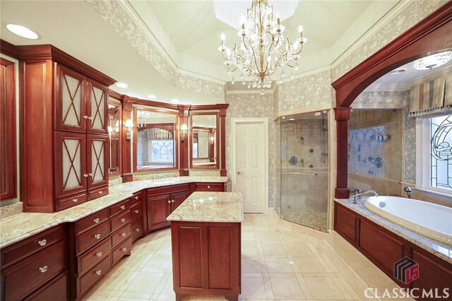 bathroom with shower with separate bathtub, vanity, ornamental molding, and a notable chandelier