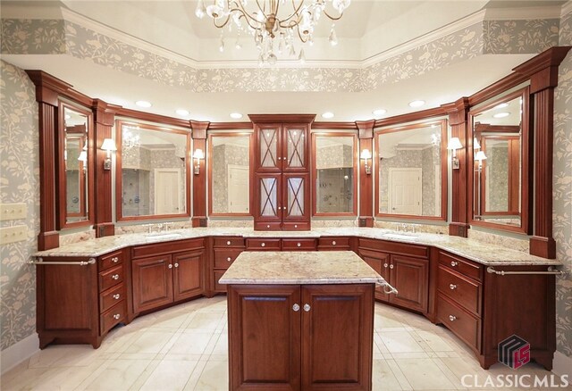 bathroom featuring vanity, crown molding, and an inviting chandelier