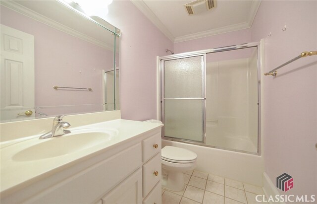 full bathroom featuring combined bath / shower with glass door, tile patterned floors, ornamental molding, vanity, and toilet