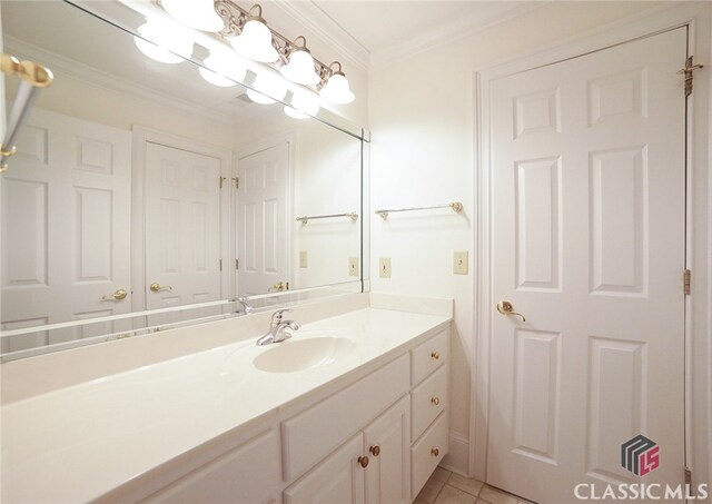 bathroom with tile patterned floors, vanity, and crown molding