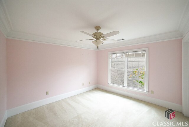 carpeted empty room with ceiling fan and crown molding