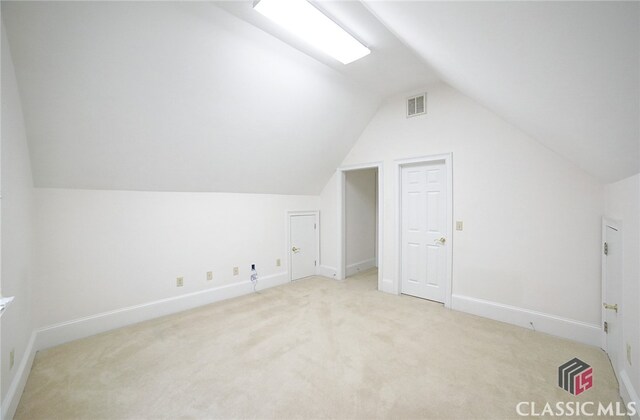 bonus room with carpet and lofted ceiling