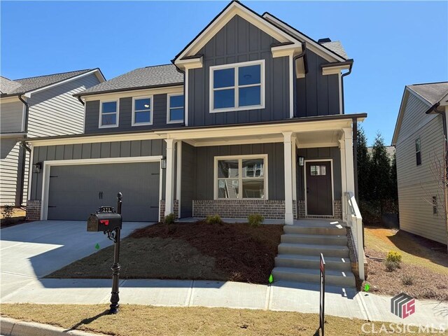 view of front of home featuring a porch and a garage