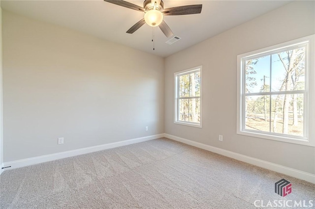 empty room with ceiling fan, light colored carpet, and ornamental molding