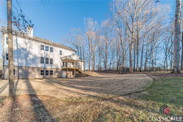 wooden deck featuring a lawn and ceiling fan