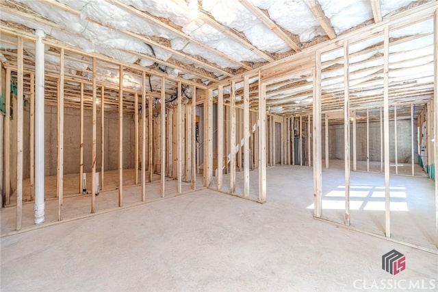 foyer entrance with wood-type flooring, a towering ceiling, and plenty of natural light