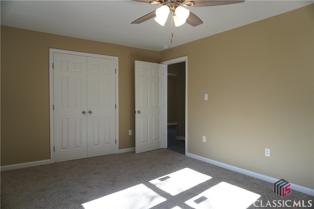 unfurnished bedroom featuring carpet, ceiling fan, and a closet