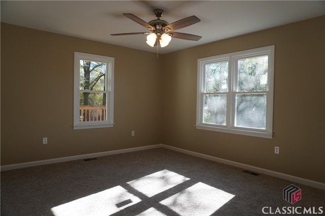 carpeted spare room with ceiling fan