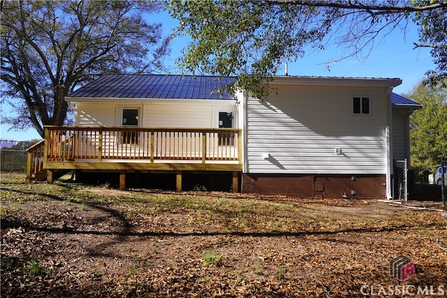 back of house with a deck