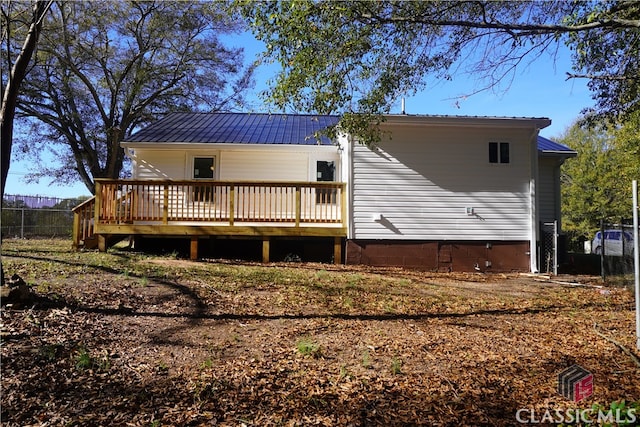 back of house with a deck