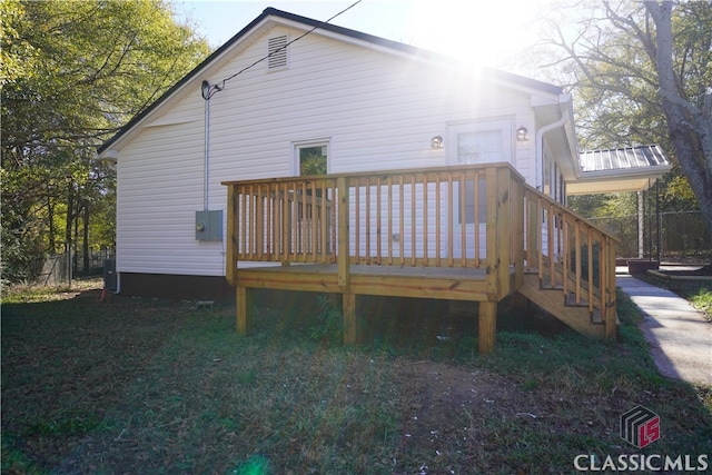 rear view of house featuring a wooden deck