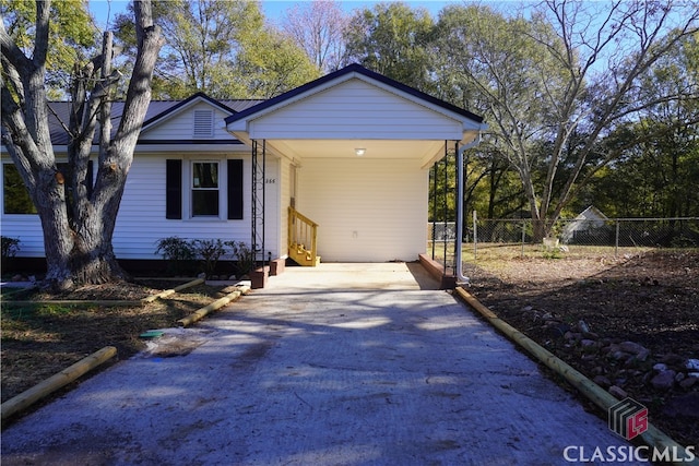 single story home featuring a carport