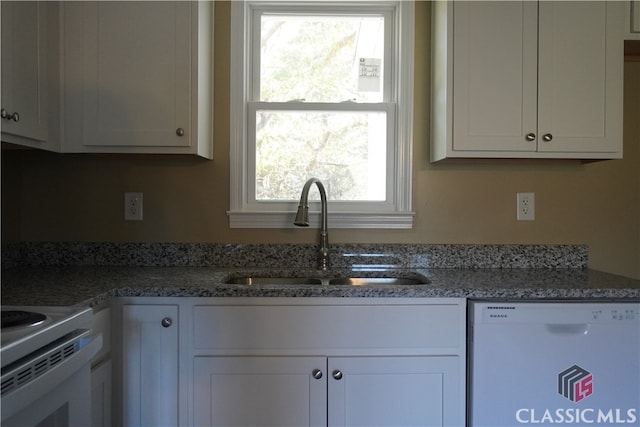 kitchen featuring white cabinetry, dishwasher, and sink