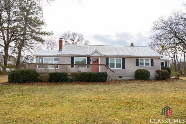 ranch-style house with a front yard and a deck