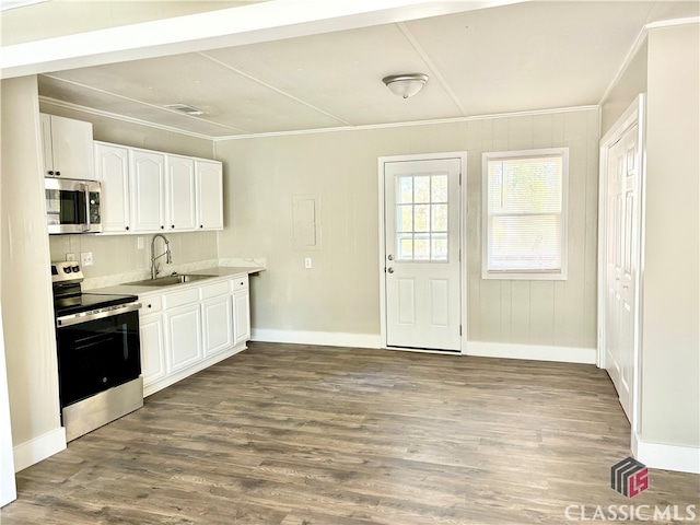 kitchen featuring sink, crown molding, dark hardwood / wood-style floors, white cabinetry, and stainless steel appliances