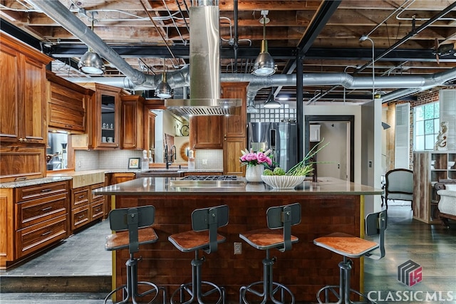 kitchen with a center island, dark wood-type flooring, and stainless steel refrigerator with ice dispenser