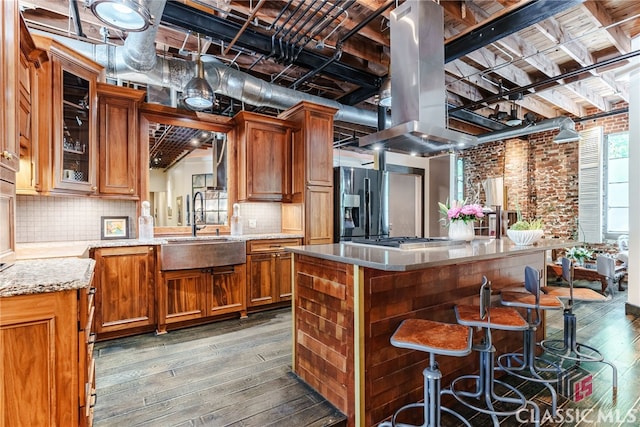 kitchen featuring a center island, dark wood-type flooring, island exhaust hood, and sink