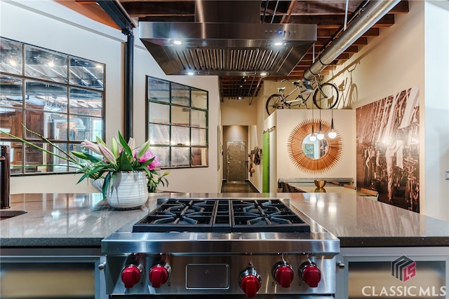 kitchen with stainless steel range oven, a high ceiling, and island exhaust hood