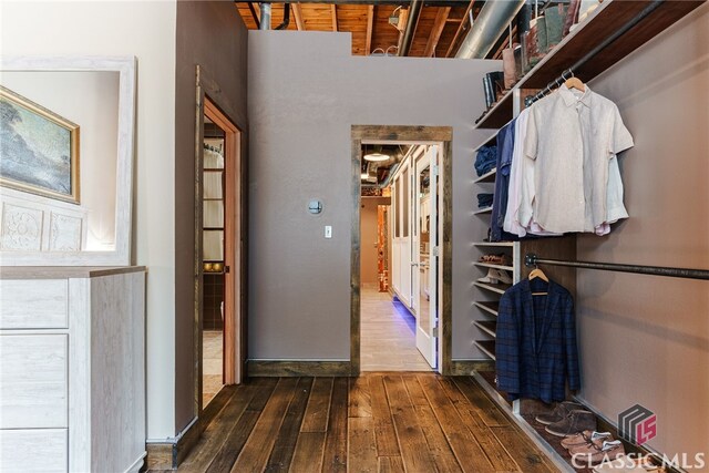 spacious closet with dark wood-type flooring