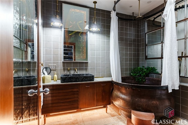 bathroom featuring tile patterned flooring, backsplash, tile walls, vanity, and a shower with shower curtain