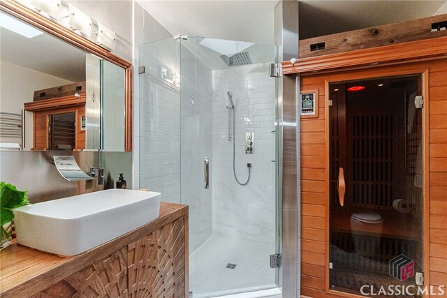 bathroom with vanity and a shower with door