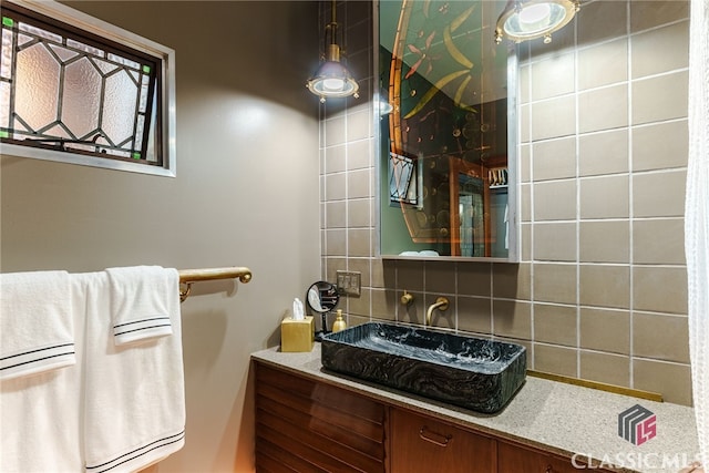 bathroom featuring vanity and decorative backsplash