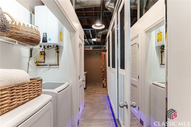 laundry area featuring tankless water heater and separate washer and dryer