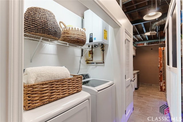 laundry room featuring tankless water heater and separate washer and dryer