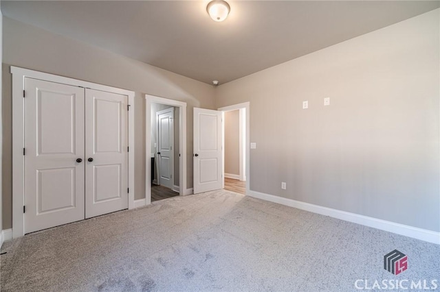 unfurnished bedroom featuring carpet and a closet