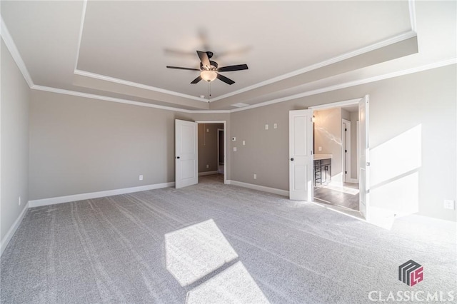 unfurnished bedroom featuring ceiling fan, light colored carpet, and a raised ceiling