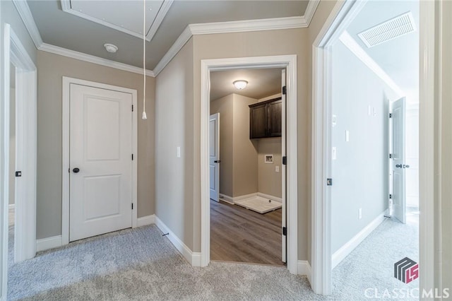 hallway featuring crown molding and light colored carpet