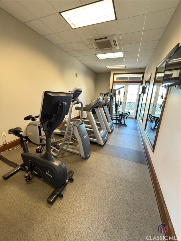 gym featuring a paneled ceiling