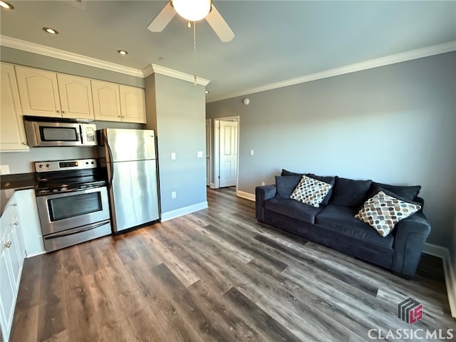 kitchen with appliances with stainless steel finishes, dark hardwood / wood-style floors, white cabinetry, and crown molding